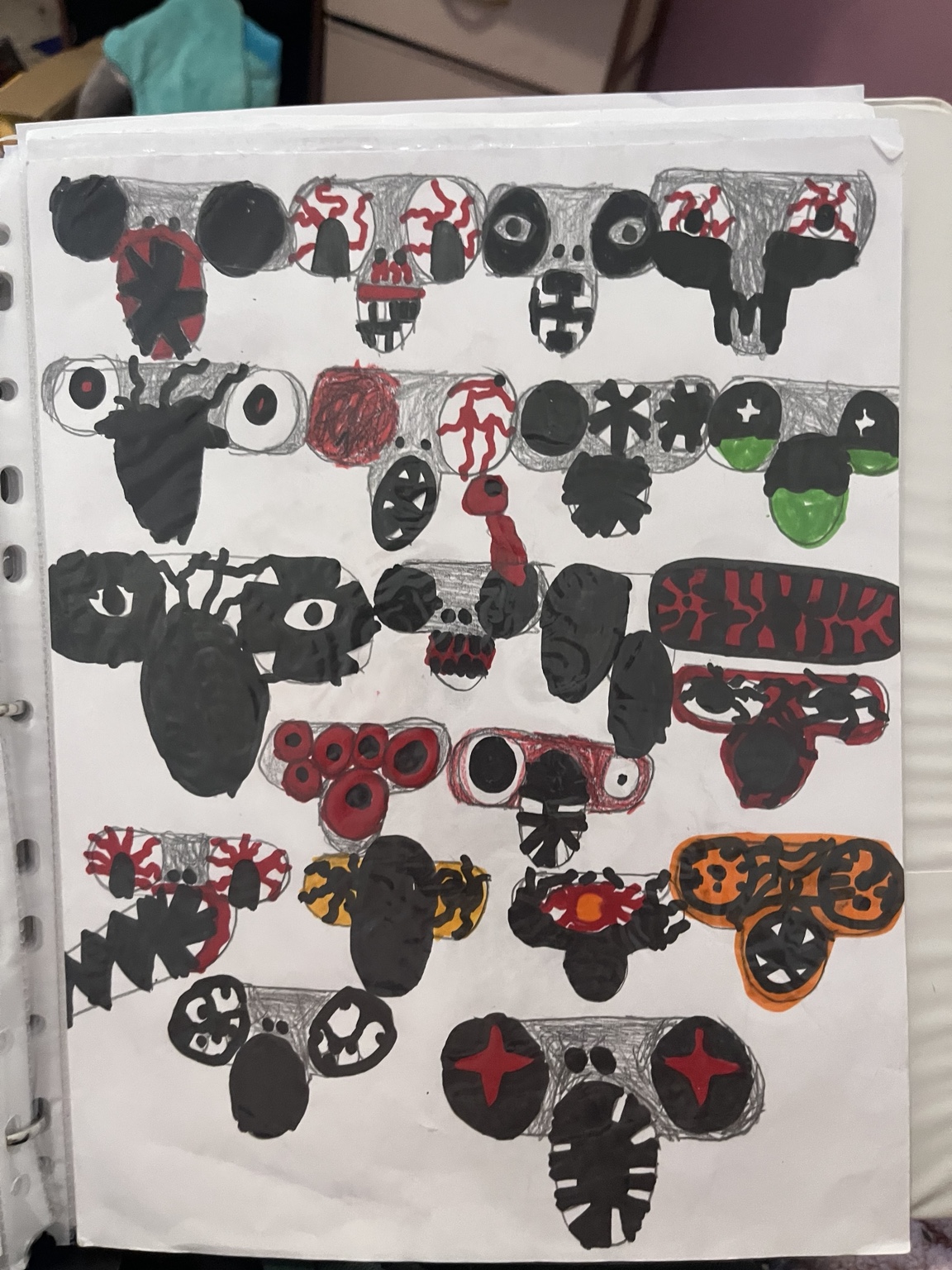 A full notebook page of original horror monster faces